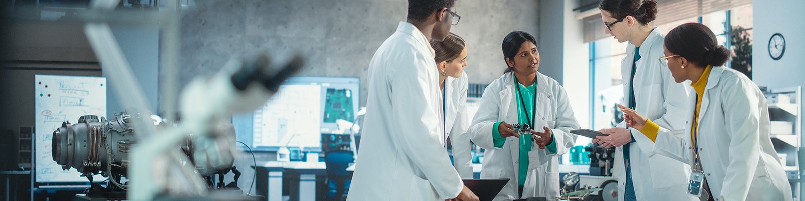 colleagues discussing their work in a chemical laboratory