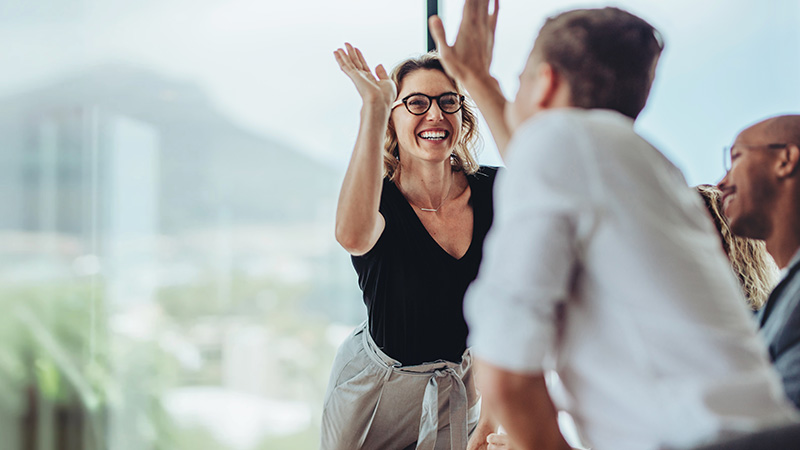high fiving colleagues